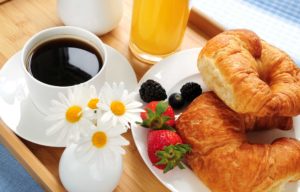 Coffee with croissants and fruit